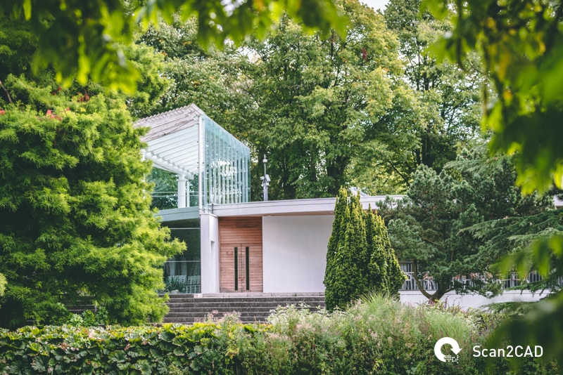 Modern minimal house surrounded by green trees